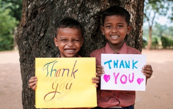 Children with thank you signs