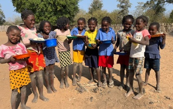children holding their plates of foo