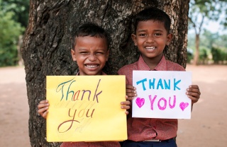 Children with thank you signs