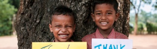 Children with thank you signs