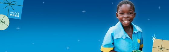 Blue background with Christmas decorations and a smiling child. 