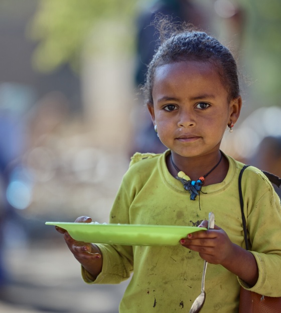 Girl eating Mary's Meals in Ethiopia