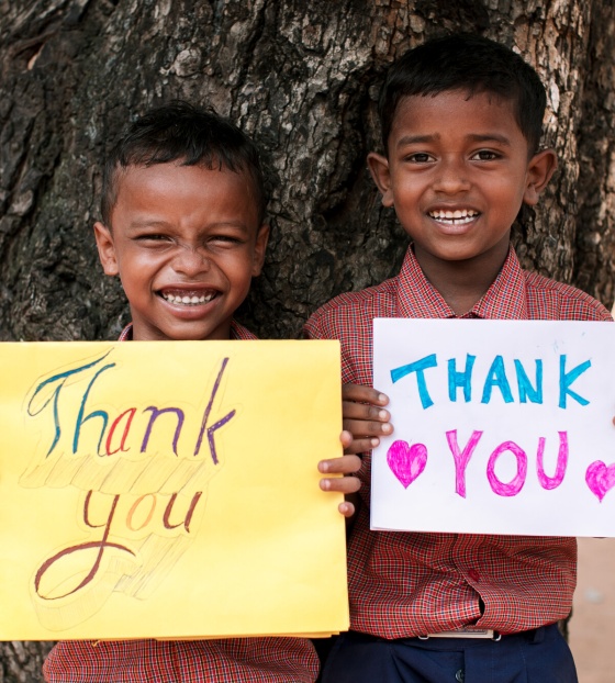 Children with thank you signs